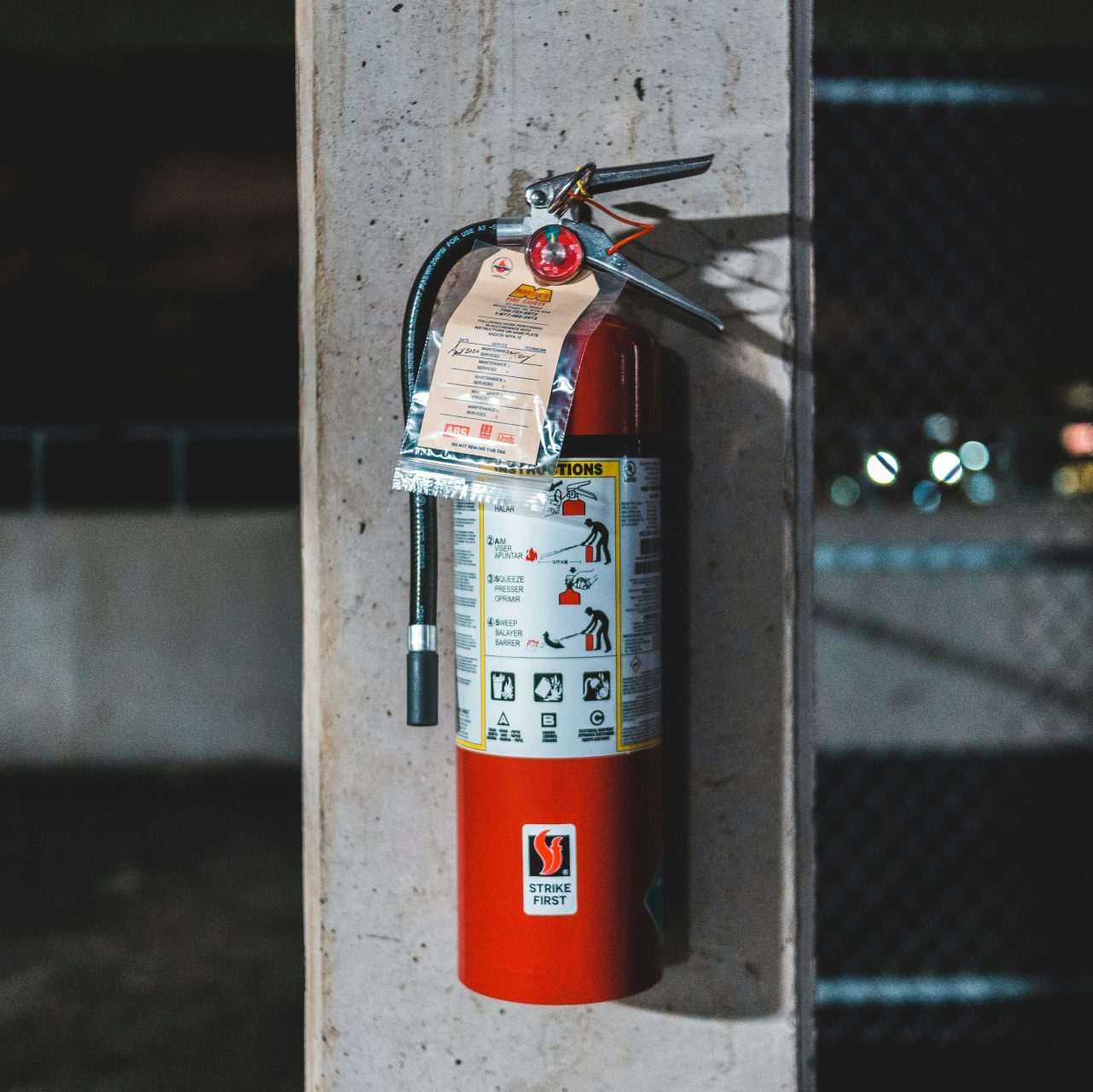 red fire extinguisher mounted on wall