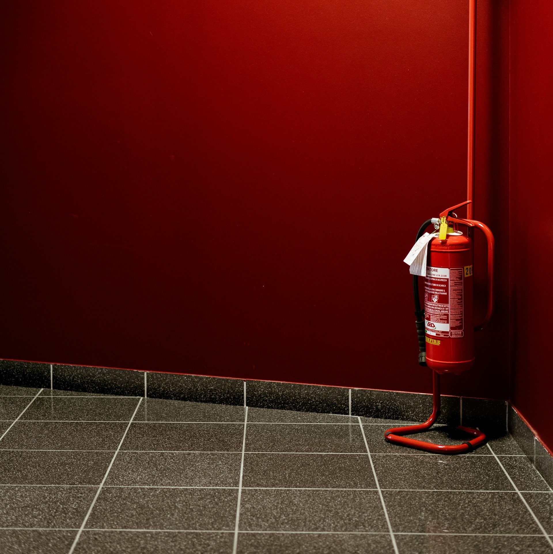 red fire extinguisher on corner